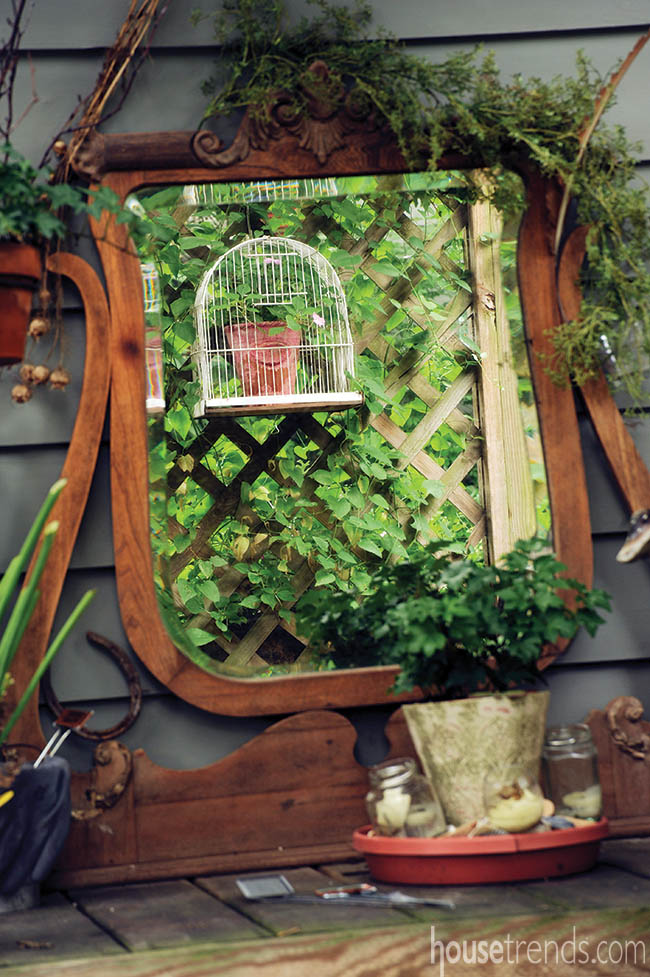 Mirror reflects a back yard