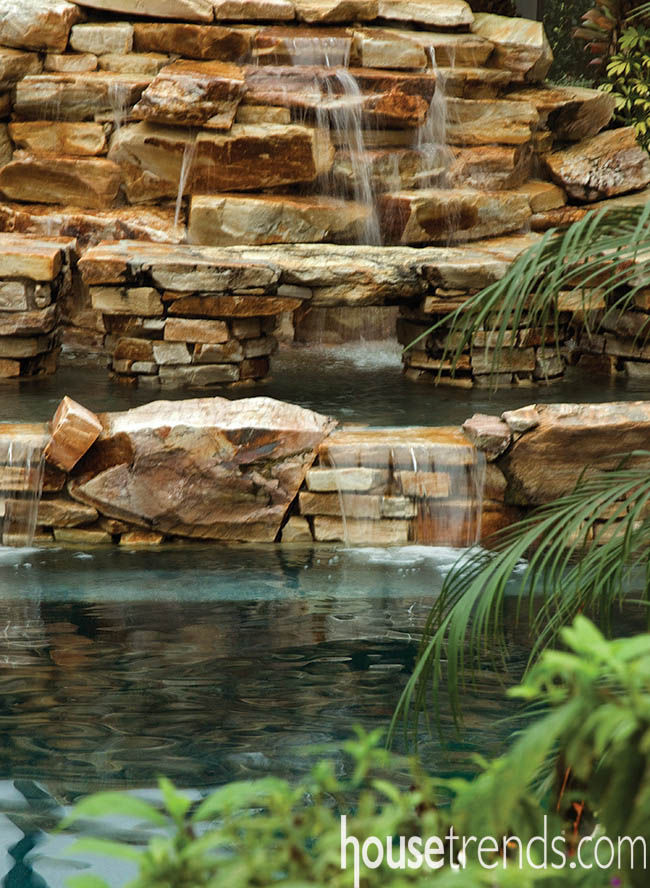 Waterfall splashes into a swimming pool