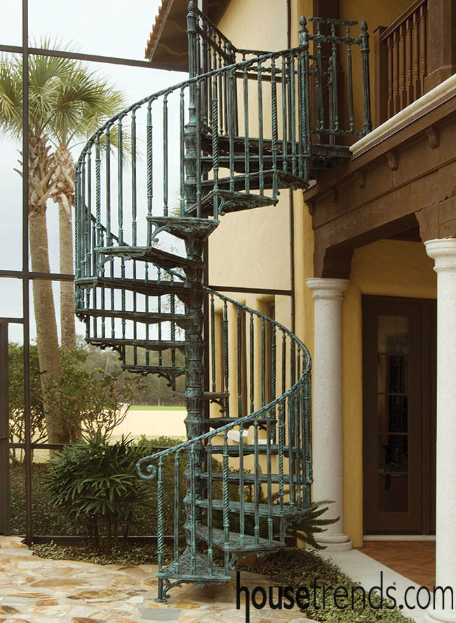 Spiral staircase winds down to an outdoor oasis