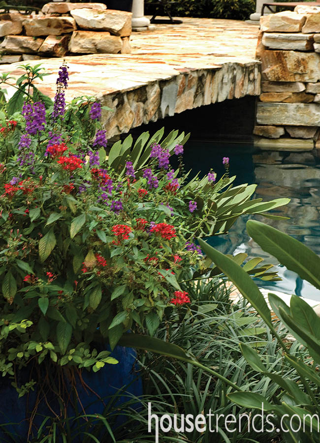 Plants add greenery and color to a covered outdoor living space