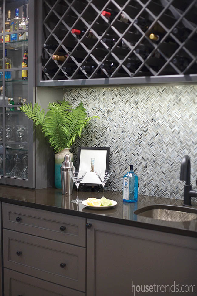 Black faucet hangs over a hammered sink
