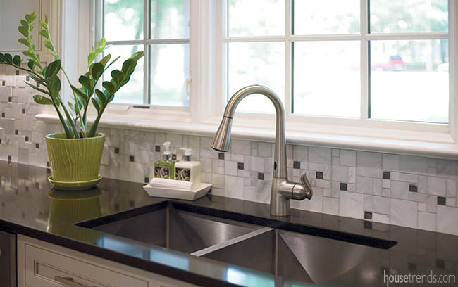 Mosaic backsplash runs the length of a kitchen