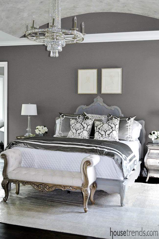 Chandelier sparkles in a gray bedroom