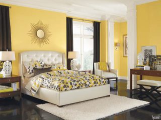 Yellow walls contribute to a cheerful bedroom design