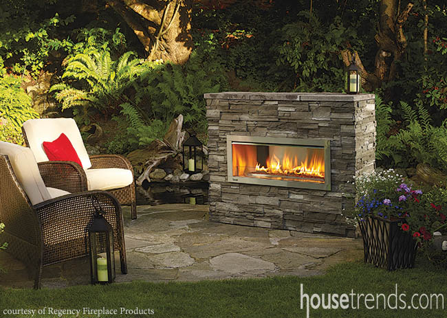 Outdoor fireplace adds a cozy touch to a paver patio