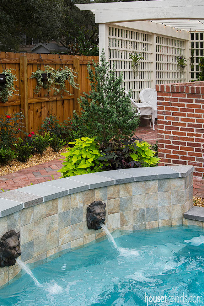 Stone wall hides pool equipment