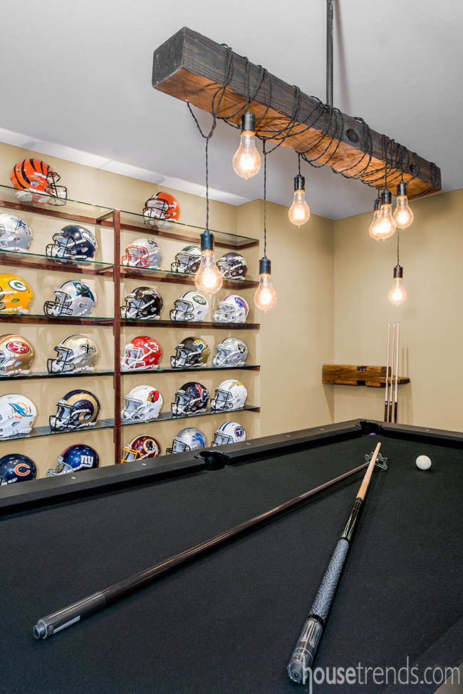 Football helmets on display in a basement