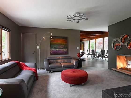 Red accessories add interest to a remodeled living room