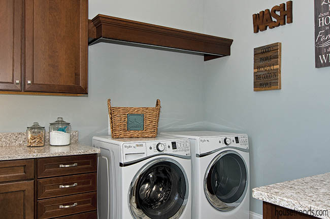 Laundry room includes plenty of work and storage space