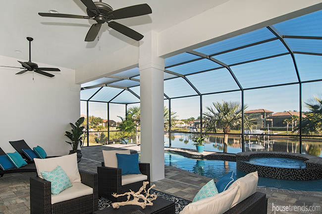 Outdoor gathering space overlooks stunning swimming pool