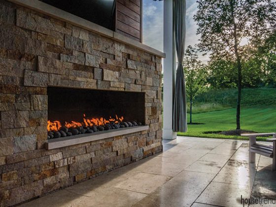Outdoor fireplace warms up a covered pavilion