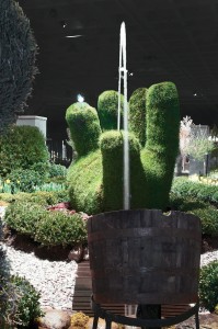 Large topiary hand with water feature