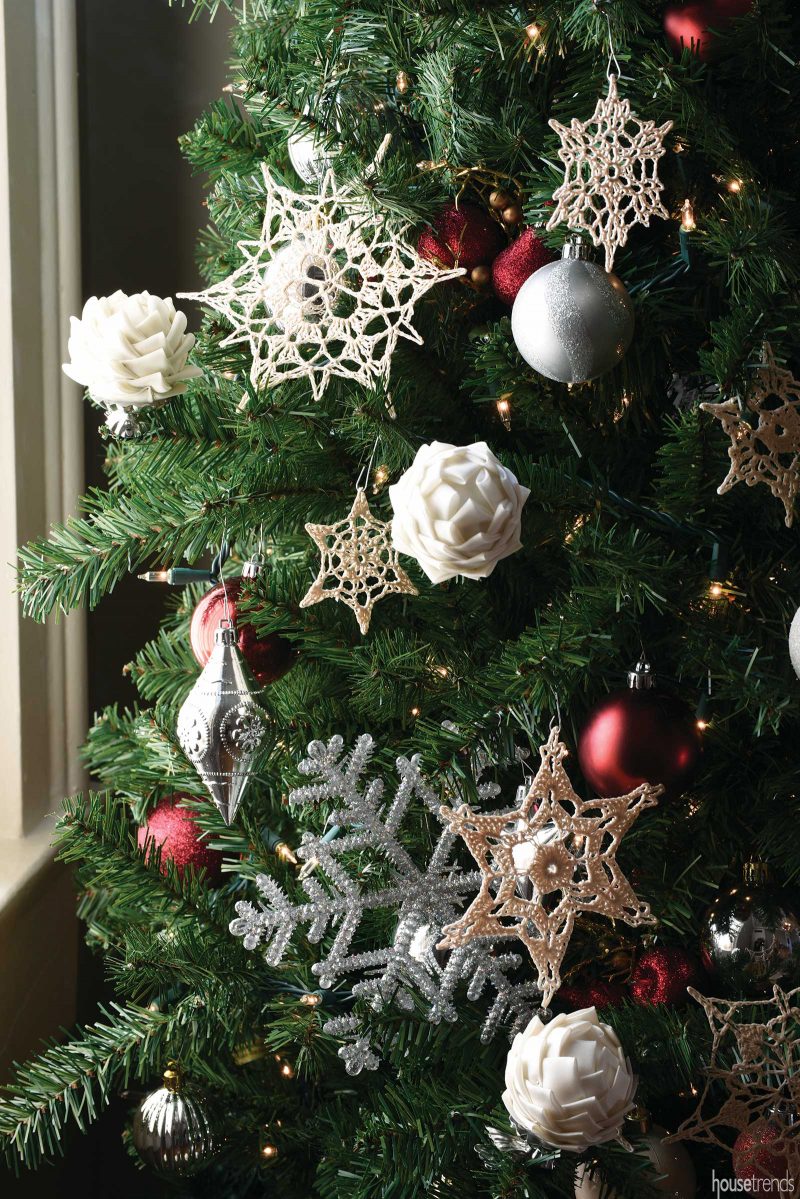 Hand-made ornaments and pinecones adorn the tree.