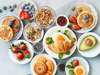 Breakfast food table. Festive brunch set, meal variety with gran