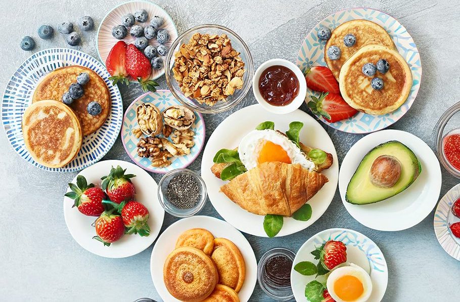 Breakfast food table. Festive brunch set, meal variety with gran